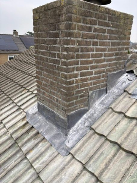 Schoorsteen met nieuw loodwerk op pannendak